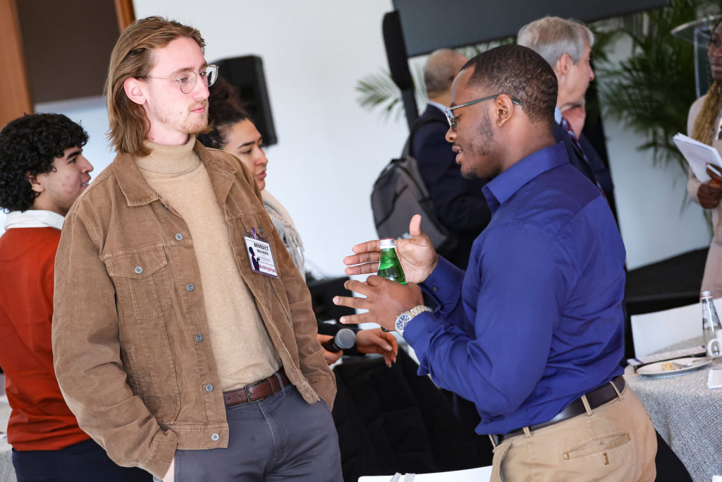 Image from Building Hope Mental Health Strategy Summit, hosted by Inseparable on November 16, 2022. Two men, one is Benedict Ballman, talking to each other.