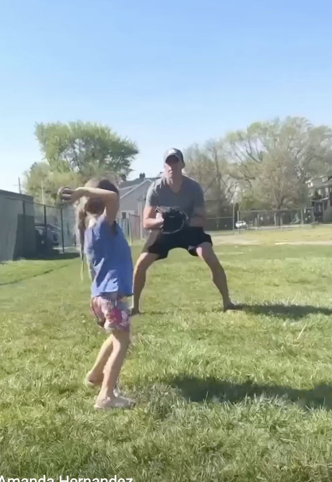 A man plays baseball with his daughter.